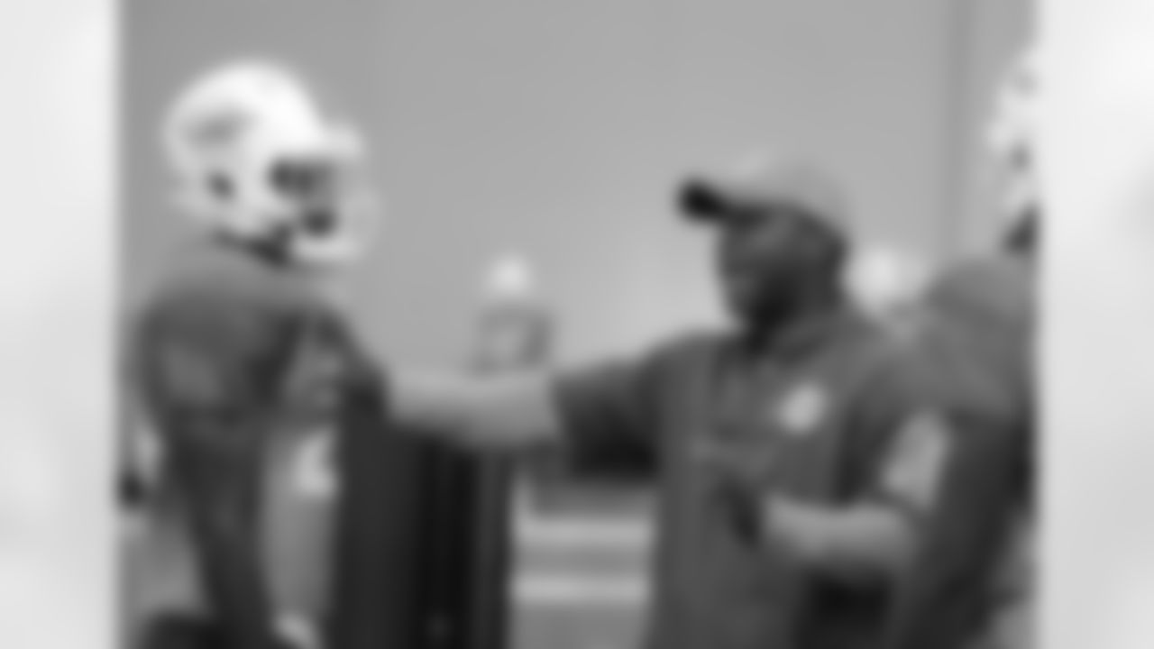 Assistant defensive backs coach Daronte Jones, right, talks with safety Isa Abdul-Quddus, left, Wednesday, Aug. 17, 2016, during practice at NFL football training camp in Davie, Fla. (AP Photo/Lynne Sladky)