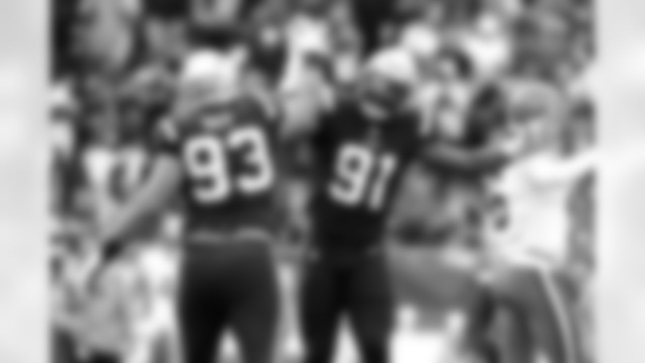 New England Patriots defensive end Deatrich Wise (91) is celebrates with Lawrence Guy (93) during the second half of an NFL football game against the Cleveland Browns, Sunday, Nov. 14, 2021, in Foxborough, Mass. At right is Cleveland Browns quarterback Baker Mayfield (6). (AP Photo/Michael Dwyer)