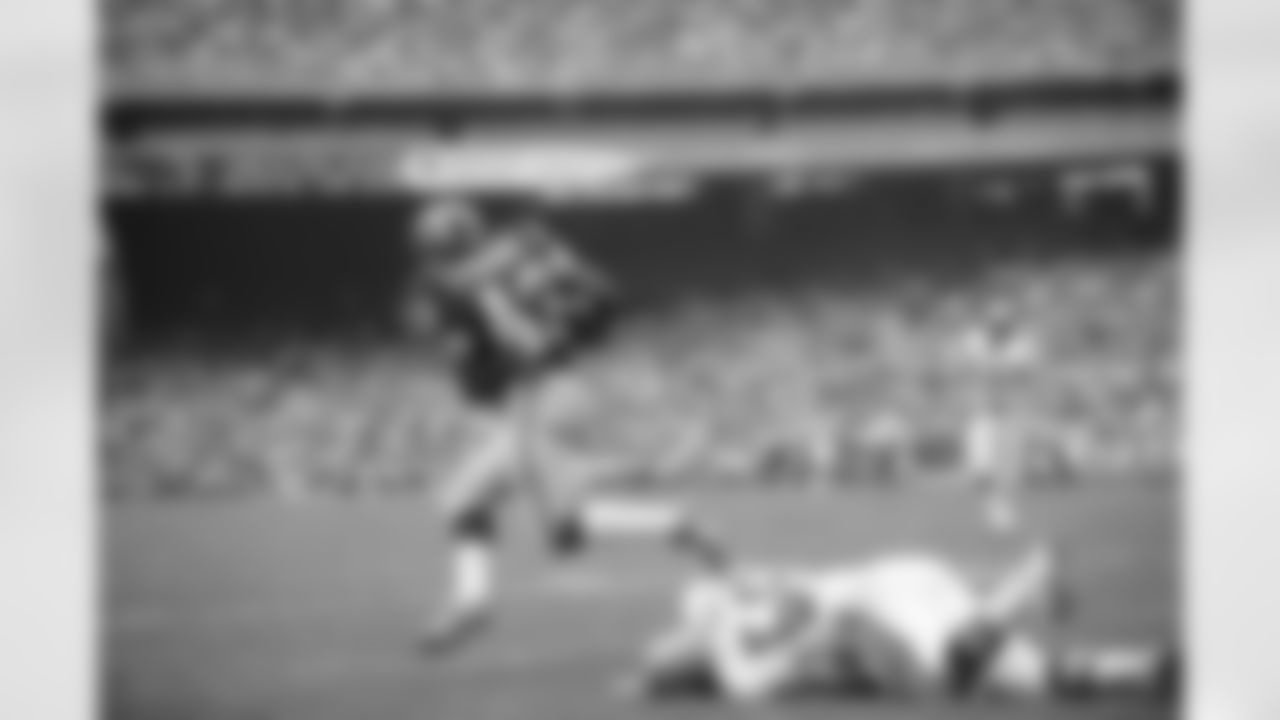 Larry Brown, 43, of the Washington Redskins, runs over Don Coleman, 55, of New Orleans, in the season's opening game in Washington on Sunday, Sept. 22, 1975. Brown, who missed the entire preseason while recovering from a knee injury, showed some of his old form in helping the Redskins beat the Saints, 41-3. (AP Photo)