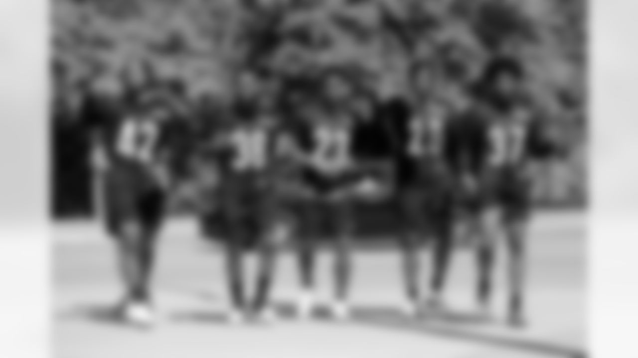 Cincinnati Bengals' Allan George (42), Bookie Radley-Hiles (38), Dax Hill (23), Tycen Anderson (26), and Delonte Hood (37) walk to the stadium after the NFL football team's rookie minicamp in Cincinnati, Friday, May 13, 2022. (AP Photo/Aaron Doster)