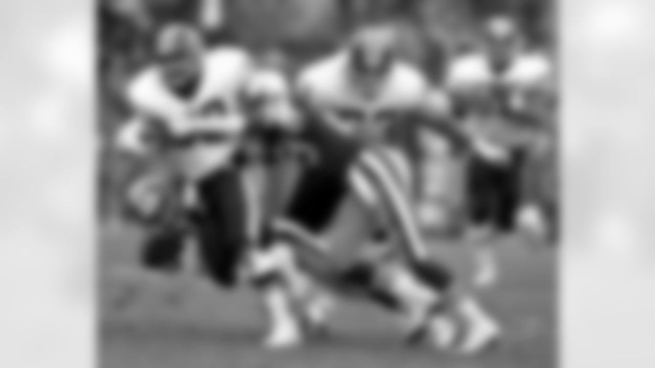 Washington Redskins running back Brian Mitchell (30) is stopped by 49ers safety Ronnie Lott (42) and cornerback Don Griffin (29) during a 28 - 10 loss to the San Francisco 49ers in the 1990 NFC Divisional Playoff Game on Jan. 12, 1991 at Candlestick Park in San Francisco. (AP Photo / Al Messerschmidt)