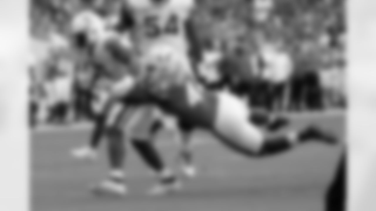 Virginia running back Mike Hollins, left, runs before being tackled by Miami defensive lineman Rueben Bain Jr. (44) during the first half of an NCAA college football game, Saturday, Oct. 28, 2023, in Miami Gardens, Fla. (AP Photo/Lynne Sladky)