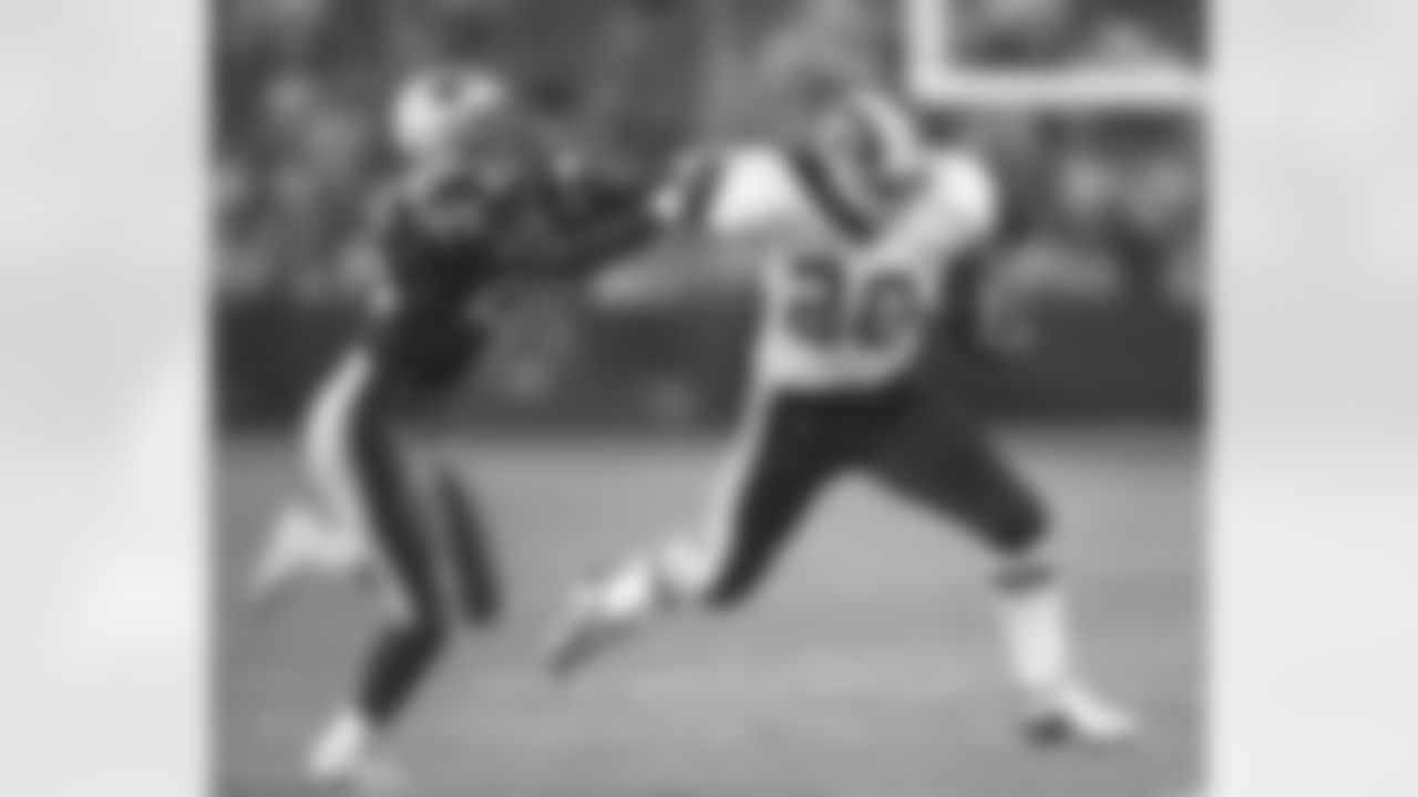 Washington Redskins running back Skip Hicks (20) stiff-arms New England Patriots' Larry Wigham during the third quarter of Washington's 20-14 win in a preseason game at Foxboro Stadium in Foxboro, Mass., Friday, Aug. 13, 1999. (AP Photo/Matt York)
