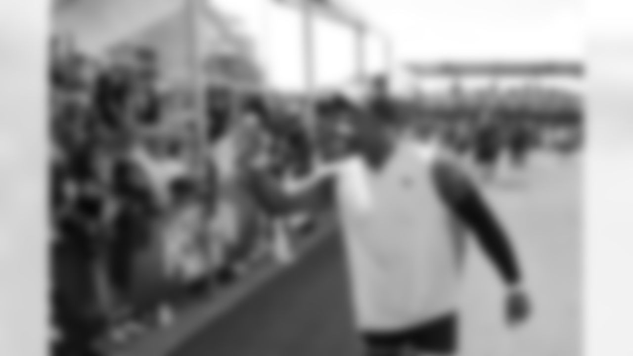 Houston Texans offensive tackle Laremy Tunsil tosses his gloves to fans after the NFL football team's training camp Sunday, July 30, 2023, in Houston. (AP Photo/Michael Wyke)
