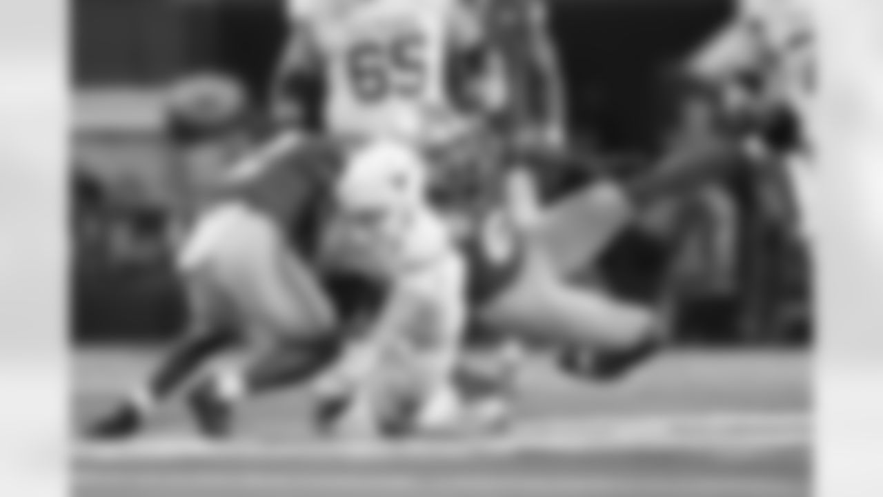 Texas quarterback Quinn Ewers, middle, runs against Ohio State safety Caleb Downs, left, and safety Sonny Styles (6) during the first half of the Cotton Bowl College Football Playoff semifinal game, Friday, Jan. 10, 2025, in Arlington, Texas. (AP Photo/Julio Cortez)