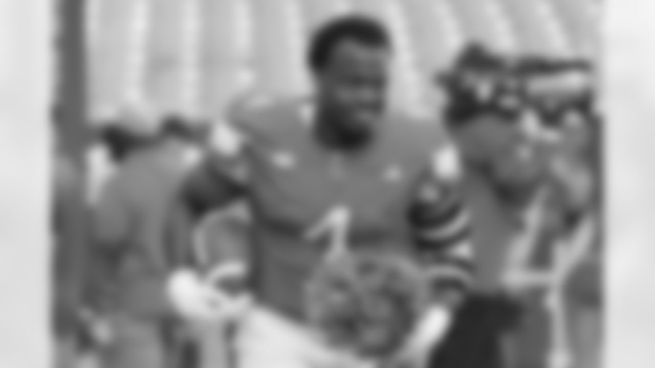Miami defensive lineman Rueben Bain Jr. (4) walks on the field with flowers during a pre-game ceremony for Senior Day before an NCAA college football game against North Carolina State, Saturday, Nov. 15, 2025, in Miami Gardens, Fla. (AP Photo/Lynne Sladky)
