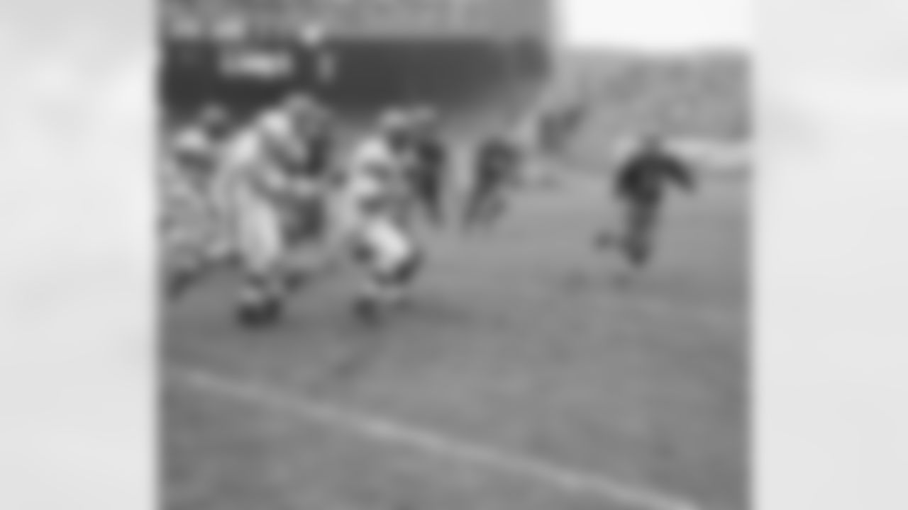 Tommy James (42) of the Cleveland?s browns takes off for a 10 yard gain after intercepting Eddie LeBaron long pass to Hugh Taylor Redskins left end. In the second Browns players moving up to block for James are Ken Gorgal (15) and Bill Willis (60). Redskins players Leon Heath (32) and Bill Dudley (35) move in to stop James in their game Nov. 1, 1953. (AP Photo)