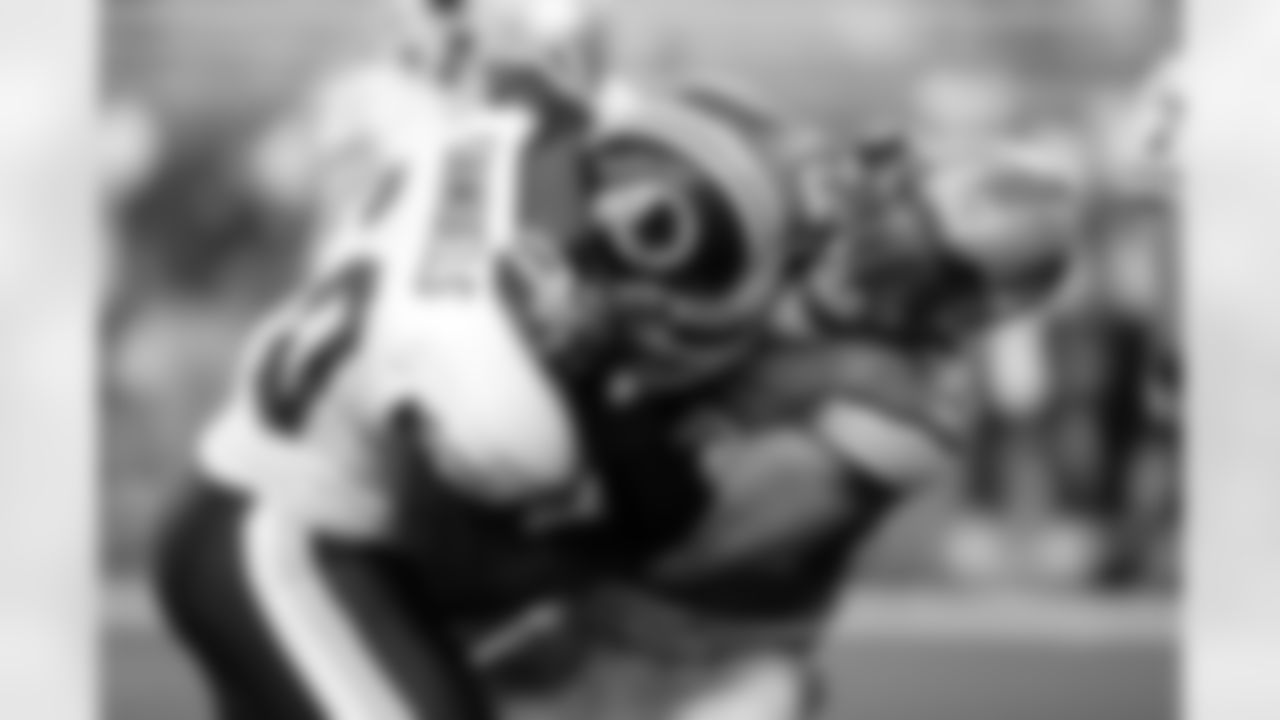 Detroit Lions' Dewayne White (99) goes up against Washington Redskins' Chris Samuels in an NFL football game Sunday, Sept. 27, 2009 in Detroit. (AP Photo/Duane Burleson)