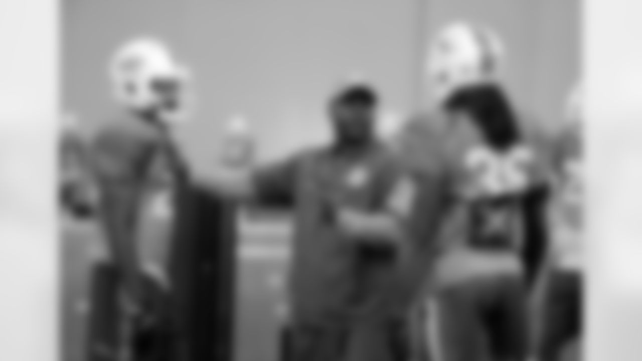 FILE - Assistant defensive backs coach Daronte Jones, center, talks with safety Isa Abdul-Quddus, left, and free safety Walt Aikens (35), during an NFL football practice in Davie, Fla., in this Wednesday, Aug. 17, 2016, file photo. Daronte Jones is the new defensive coordinator for the LSU NCAA college football team. Jones had an introductory media conference on Tuesday, Feb. 2, 2021. (AP Photo/Lynne Sladky, FIle)