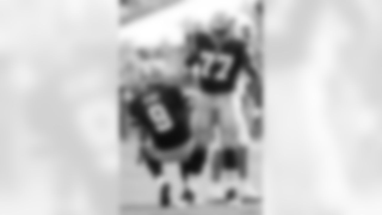 Tony Romo #9 of the Dallas Cowboys is helped up by Tyron Smith #77 after throwing an interception against the Miami Dolphins during an NFL football game on Nov. 22, 2015 in Miami Gardens, Fla. Dallas defeated Miami 24-14. (Joe Robbins via AP)