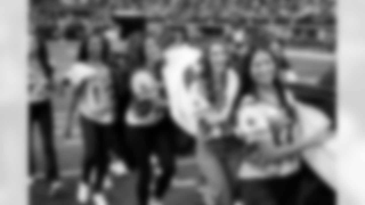 19 October 2025:   Cheerleaders alumni hold the field sized United States flag for the national anthem
of the Dallas Cowboys during their regular season 44-22 win over the Washington Commanders at AT&T Stadium in Arlington, Texas.  Photo by James D. Smith/Dallas Cowboys