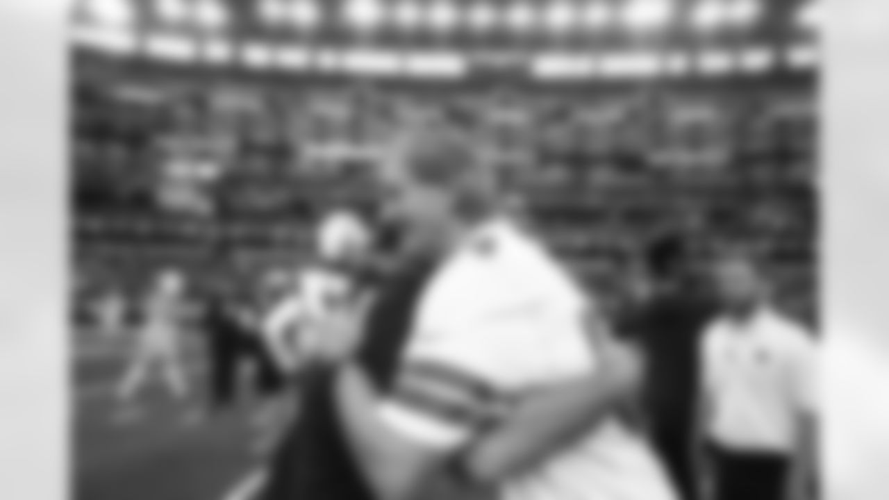 Former Pro Bowl tight end Doug Cosbie visits with a member of the Cowboys coaching staff.