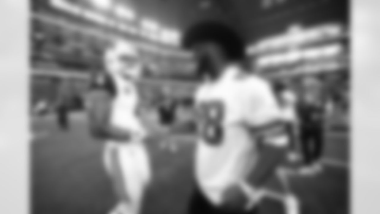 Former teammates Dak Prescott and Dez Bryant chat before the game Sunday.