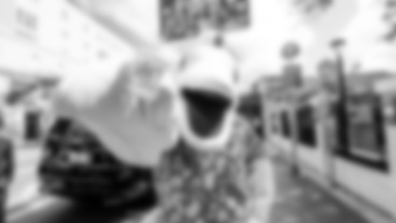 TD holds up a "Celebrate the 305
 cafecito cup.