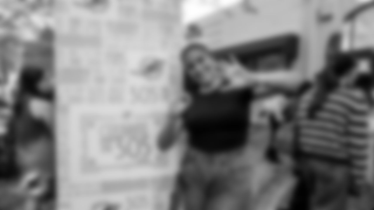 A woman holds up the iconic 305 sign with her hands.