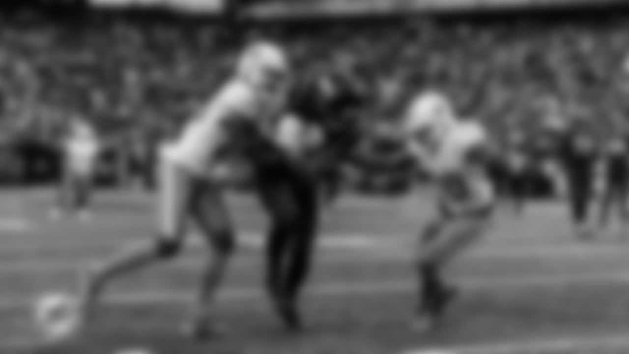 Miami Dolphins cornerback Rasul Douglas (26) and linebacker Jordyn Brooks (20) make a tackle during an NFL football game against the New York Jets on Sunday, Dec. 7, 2025 in East Rutherford, NJ. (Tomas Diniz Santos/Miami Dolphins via AP)