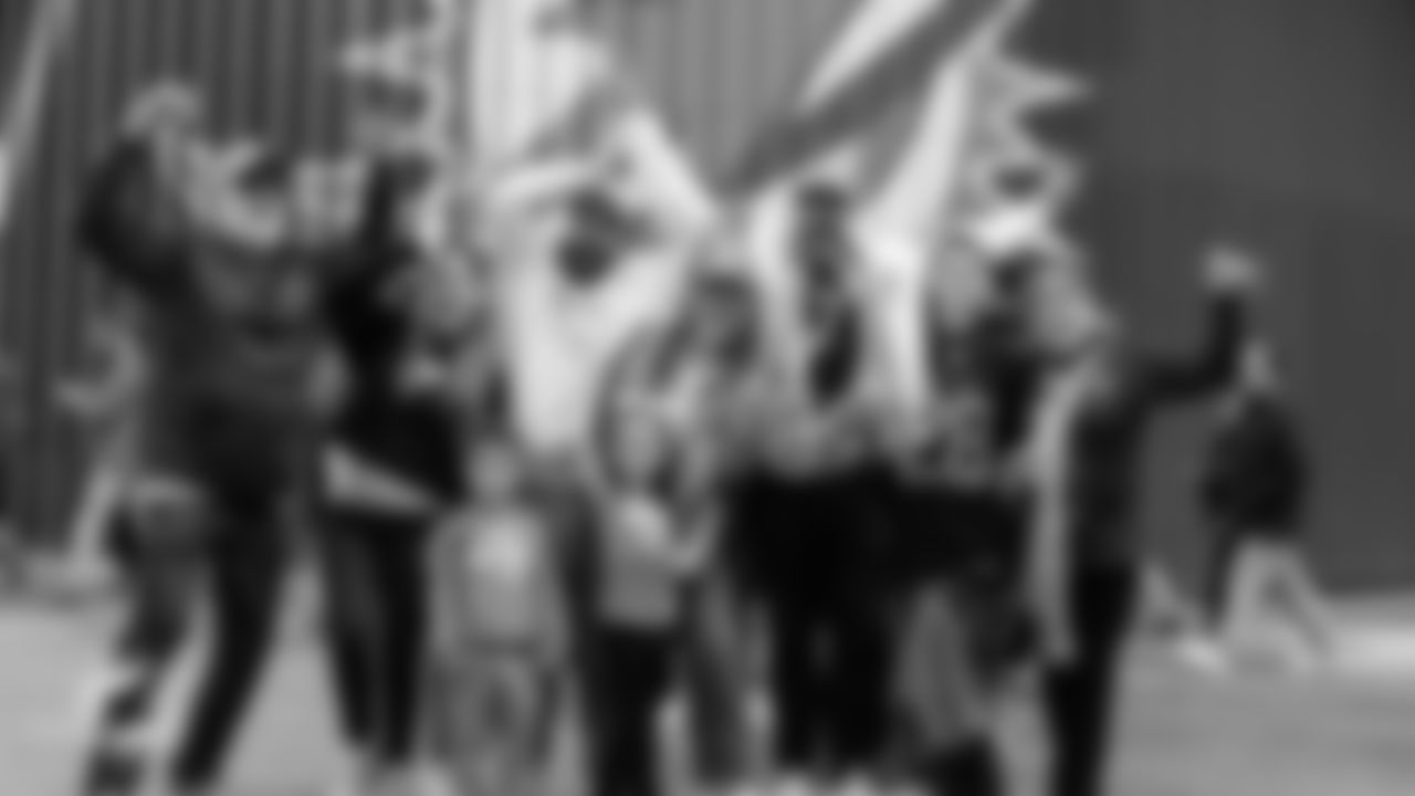 Miami Dolphins fans pose before an NFL football game against the Washington Commanders on Sunday, Nov. 16, 2025 in Madrid. (Robby Illanes/Miami Dolphins via AP)