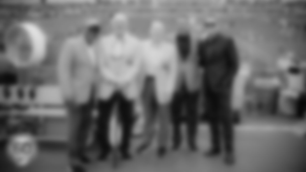 Miami Dolphins Hall of Fame alum Nat Moore, Larry Csonka, Bob Griese and Dan Marino pose on the sideline with President and CEO Tom Garfinkel during an NFL football game against the Cincinnati Bengals on Sunday, Dec. 21, 2025 in Miami Gardens, FL. (Tomas Diniz Santos/Miami Dolphins via AP)