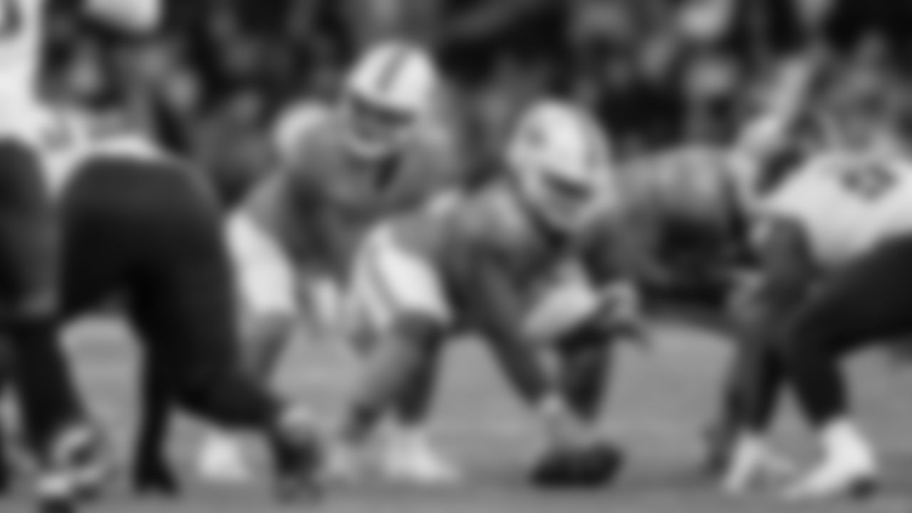 Miami Dolphins quarterback Tua Tagovailoa (1) and offensive lineman Aaron Brewer (55) set at the line of scrimmage during an NFL football game against the Washington Commanders on Sunday, Nov. 16, 2025 in Madrid. (Tomas Diniz Santos/Miami Dolphins via AP)