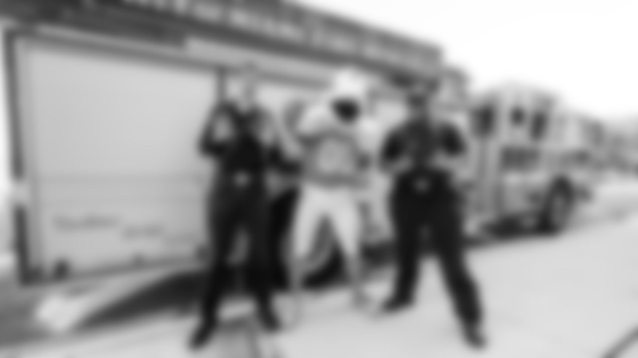 TD poses with members of the City of Miami Fire Rescue in front of their truck.