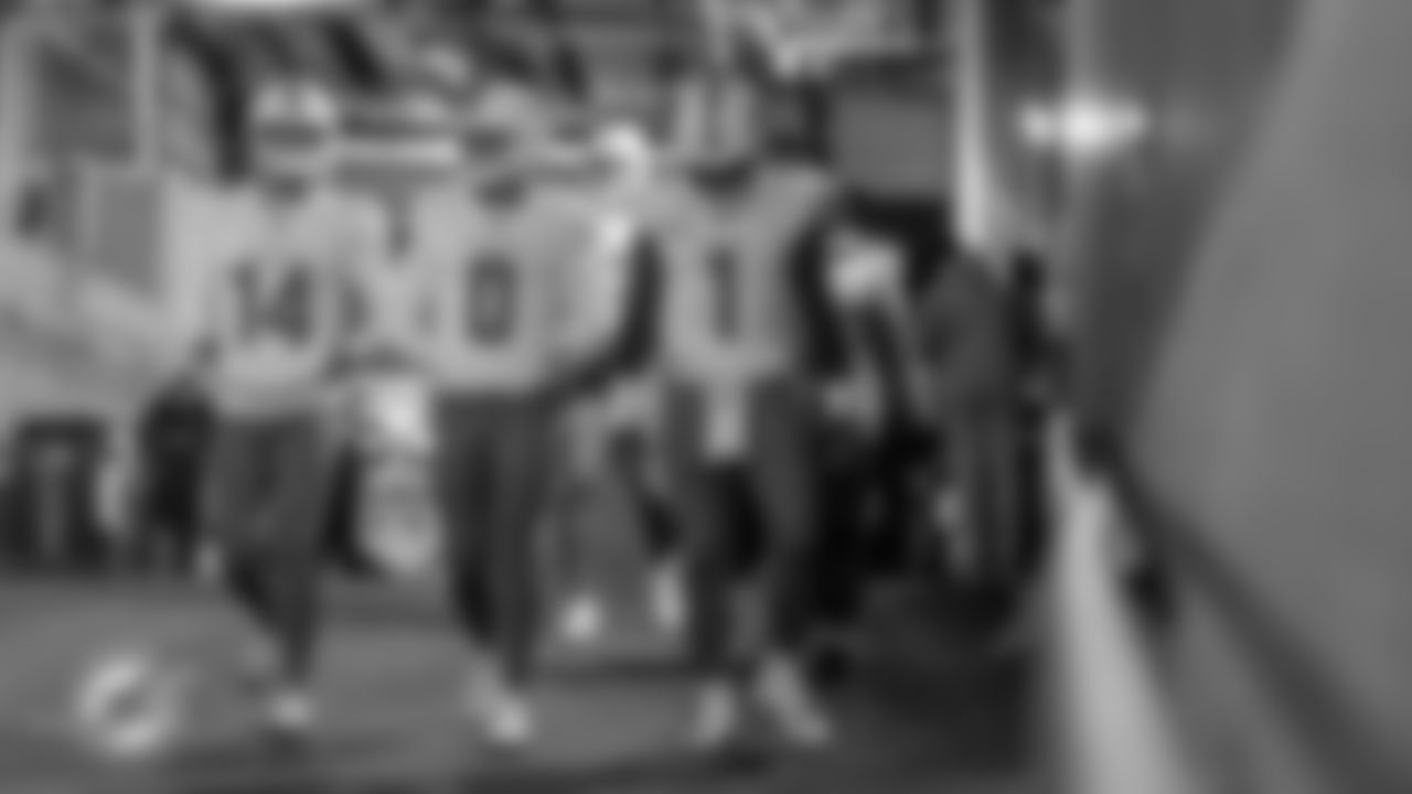 Miami Dolphins quarterbacks Quinn Ewers (14), Zach Wilson (0) and Tua Tagovailoa (1) exit the tunnel before an NFL football game against the New York Jets on Sunday, Dec. 7, 2025 in East Rutherford, NJ. (Raul Maristany/Miami Dolphins via AP)