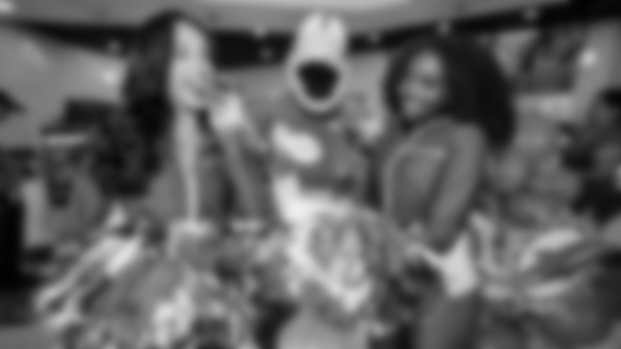 TD and cheerleaders try pastelitos at Vicky Bakery.