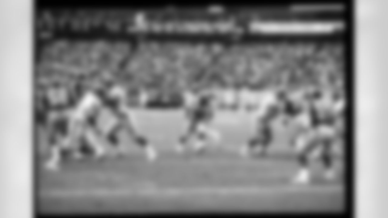 Historical photograph of Gerald Riggs during Falcons game day action in the 1980s.