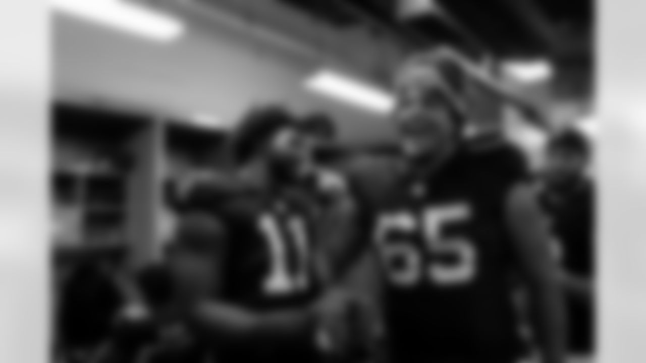 Atlanta Falcons edge rusher Jalon Walker #11 and Atlanta Falcons offensive lineman Matthew Bergeron #65 celebrate in the locker room during the Week 15 Game against the Tampa Bay Buccaneers at Raymond James Stadium in Tampa, Florida on Thursday, December 11, 2025. (Photo by Jay Bendlin/Atlanta Falcons)