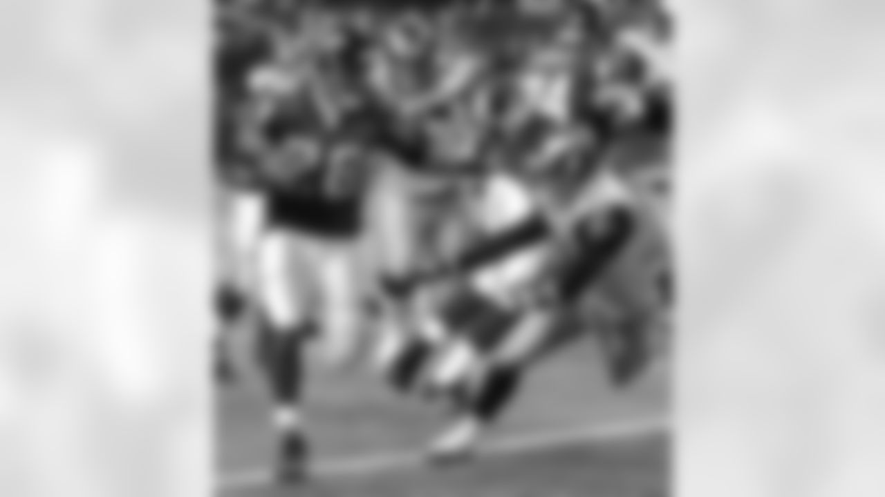 Atlanta Falcons running back Warrick Dunn (28) gets past St. Louis Rams safety Adam Archuleta (31) and end Erik Flowers (96) with help from tackle Todd Weiner (74) for a first half touchdown NFC Divisional Playoffs at the Georgia  Dome in Atlanta, Saturday, Jan. 15, 2005. (AP Photo/Chris O'Meara)