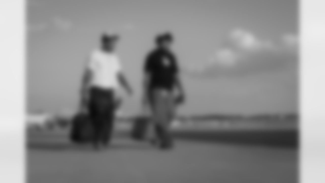 Atlanta Falcons cornerback Mike Hughes #21 and Atlanta Falcons linebacker Josh Woods #42 boards the plane at Hartsfield-Jackson International Airport in Atlanta, Ga. on Saturday, November 22, 2025. (Photo by Jay Bendlin/Atlanta Falcons)