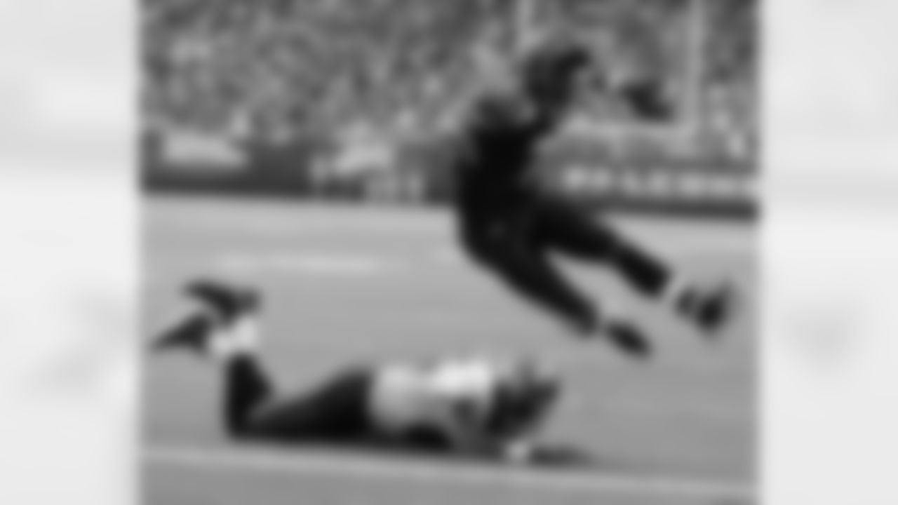 FILE - In this Sept. 17, 2006, file photo, Atlanta Falcons quarterback Michael Vick leaps over Tampa Bay Buccaneers linebacker Derrick Brooks (55) for a first quarter touchdown during an NFL football game at the Georgia Dome in Atlanta. Vick never made it to the Super Bowl with the Falcons. And his career with the team ended in disgrace. Yet no one is rooting harder for the Falcons to win their first championship. (AP Photo/John Amis, File)