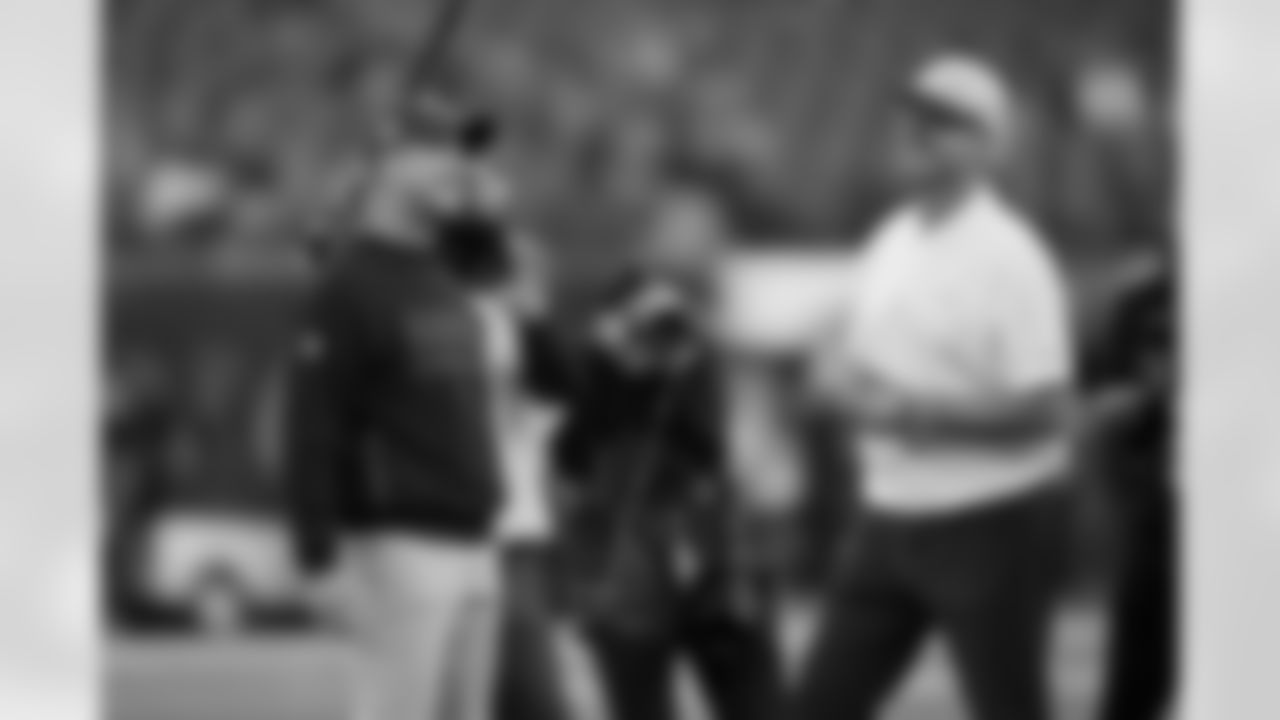 Los Angeles Chargers head coach Jim Harbaugh, right, talks to his brother, Baltimore Ravens Head Coach John Harbaugh, before an NFL football game Monday, Nov. 25, 2024, in Inglewood, Calif. (AP Photo/Eric Thayer)