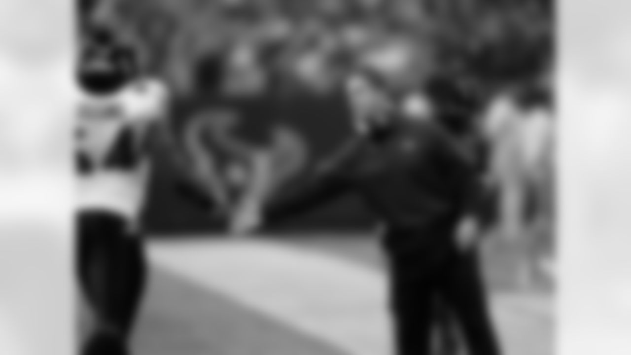 Baltimore Ravens coach John Harbaugh welcomes Oniel Cousins during the first quarter of an NFL football game against the Houston Texans Monday, Dec. 13, 2010, in Houston. (AP Photo/David J. Phillip)