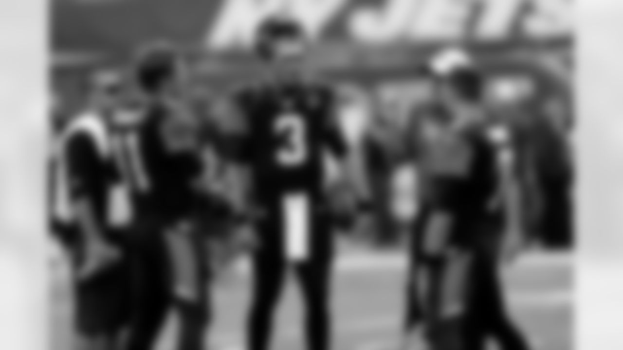 Jacksonville Jaguars quarterback Blaine Gabbert (11), quarterback Mike Kafka (3) and quarterback Chad Henne (7) talk before an NFL preseason football game against the New York Jets, Saturday, Aug. 17, 2013, in East Rutherford, N.J. (AP Photo/Seth Wenig)