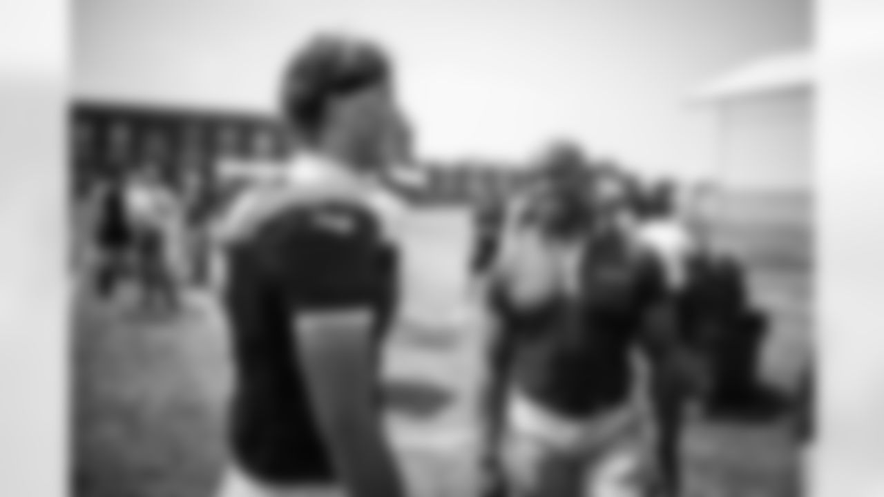 QB Jaxson Dart (6) and Tiki Barber