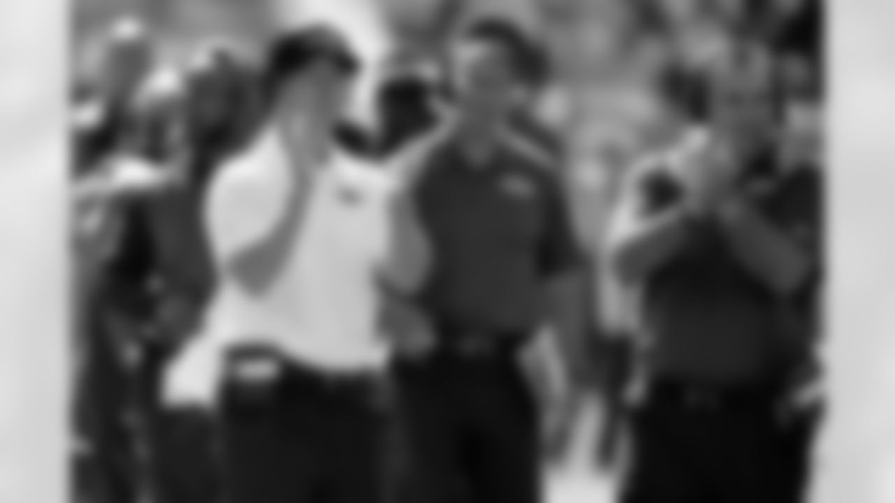 Baltimore Ravens tight ends coach Brian Pariani, right, celebrates with head coach John Harbaugh during an NFL football game against the Cleveland Browns Sunday, Sept. 21, 2014, in Cleveland. Baltimore won 23-21. (AP Photo/David Richard)