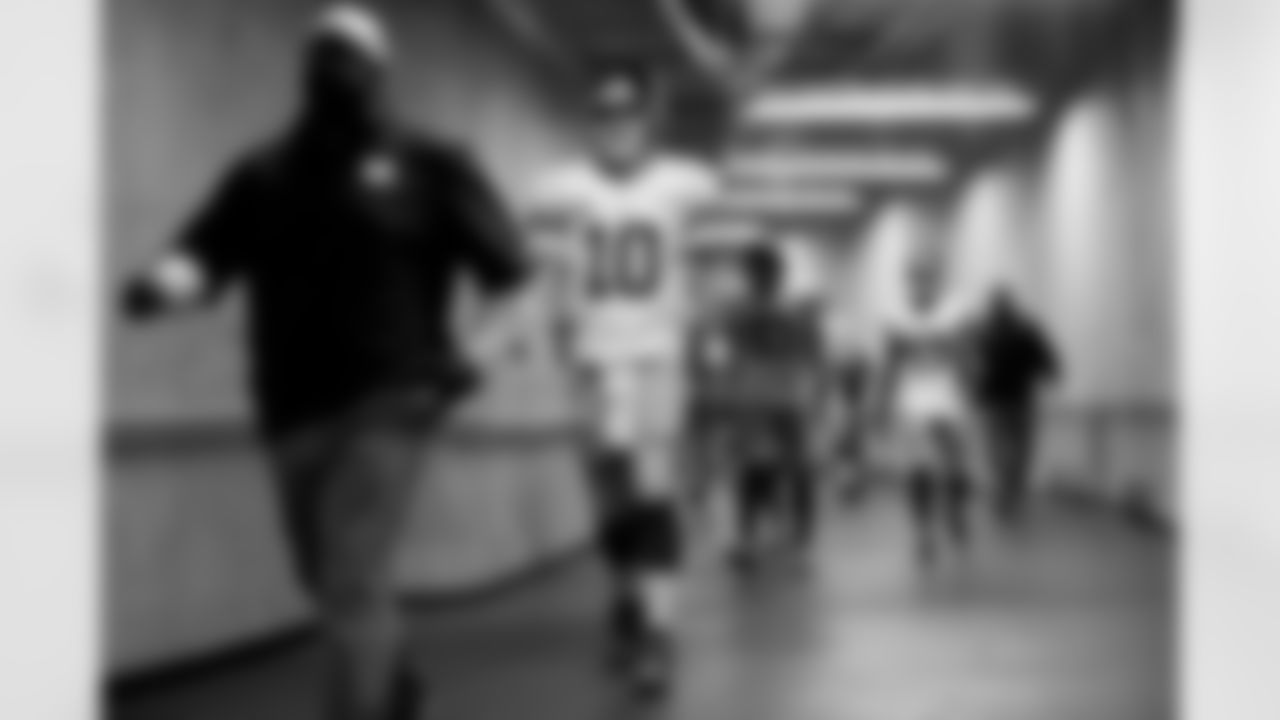 New York Giants quarterback Eli Manning (10) makes his way to the field before an NFL football game against the Detroit Lions in Detroit, Sunday, Dec. 22, 2013. (AP Photo/Paul Sancya)