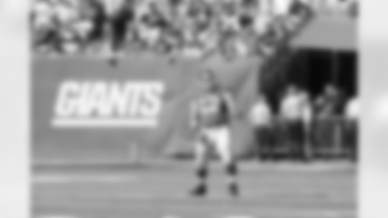New York Giants offensive lineman Mitch Petrus (62) plays air guitar before the Giants play against the Detroit Lions in a week 6 NFL football game at the New Meadowlands Stadium in East Rutherford, New Jersey on Sunday October 17, 2010 (AP Photo/Evan Pinkus)