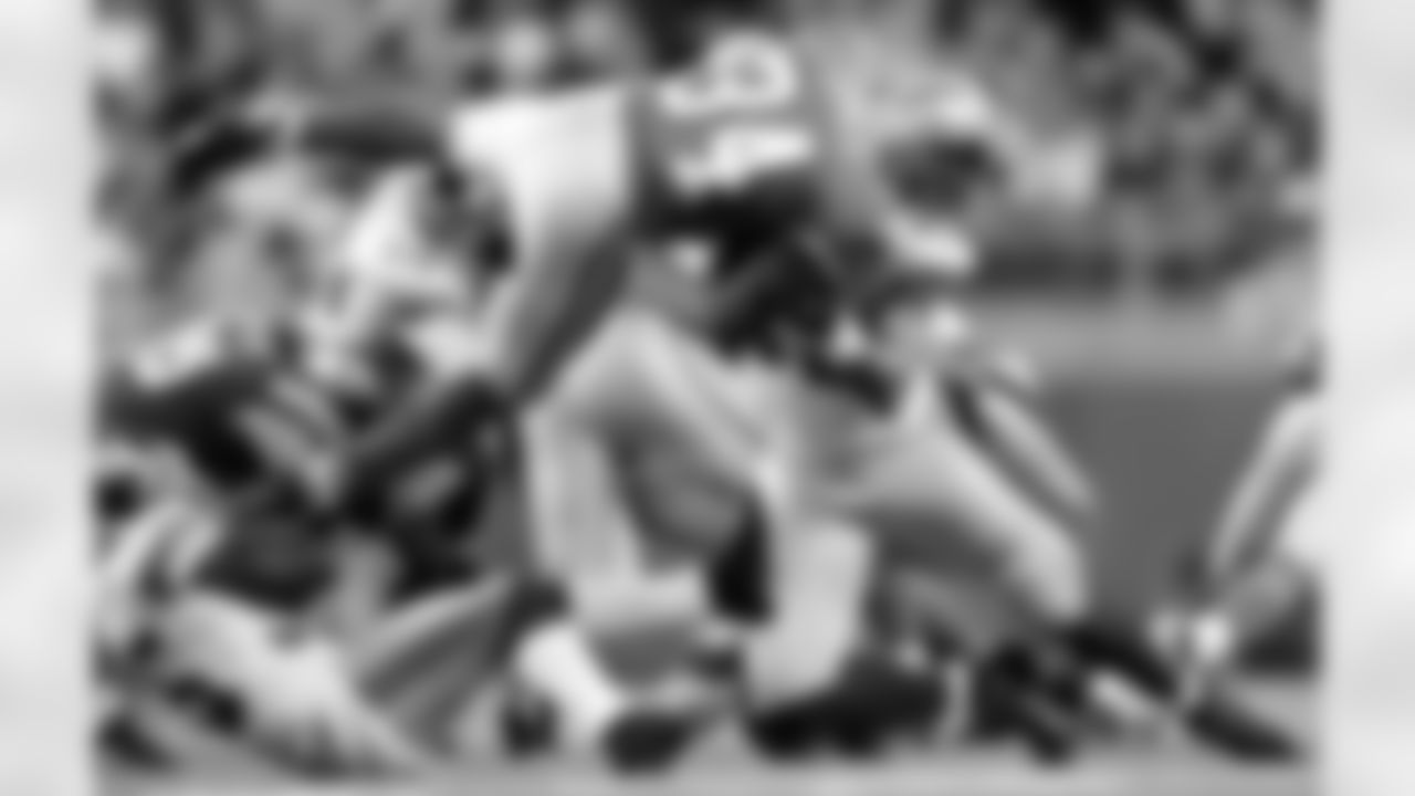 New York Giants defensive end Michael Strahan, right, stops Detroit Lions running back Kevin Jones (34) in mid air as Giants cornerback Kevin Dockery, left, holds his foot for a 5 yard loss in the second quarter of an NFL football game in Detroit, Sunday, Nov. 18, 2007. (AP Photo/Paul Sancya)