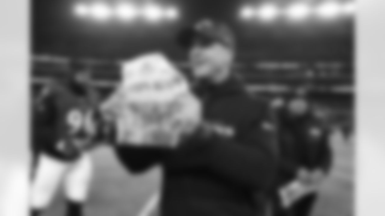 Baltimore Ravens head coach John Harbaugh holds a newspaper after his team wins the AFC North division in an NFL football game against the Cleveland Browns, Saturday, Jan. 4 2025, in Baltimore. (AP Photo/Terrance Williams)