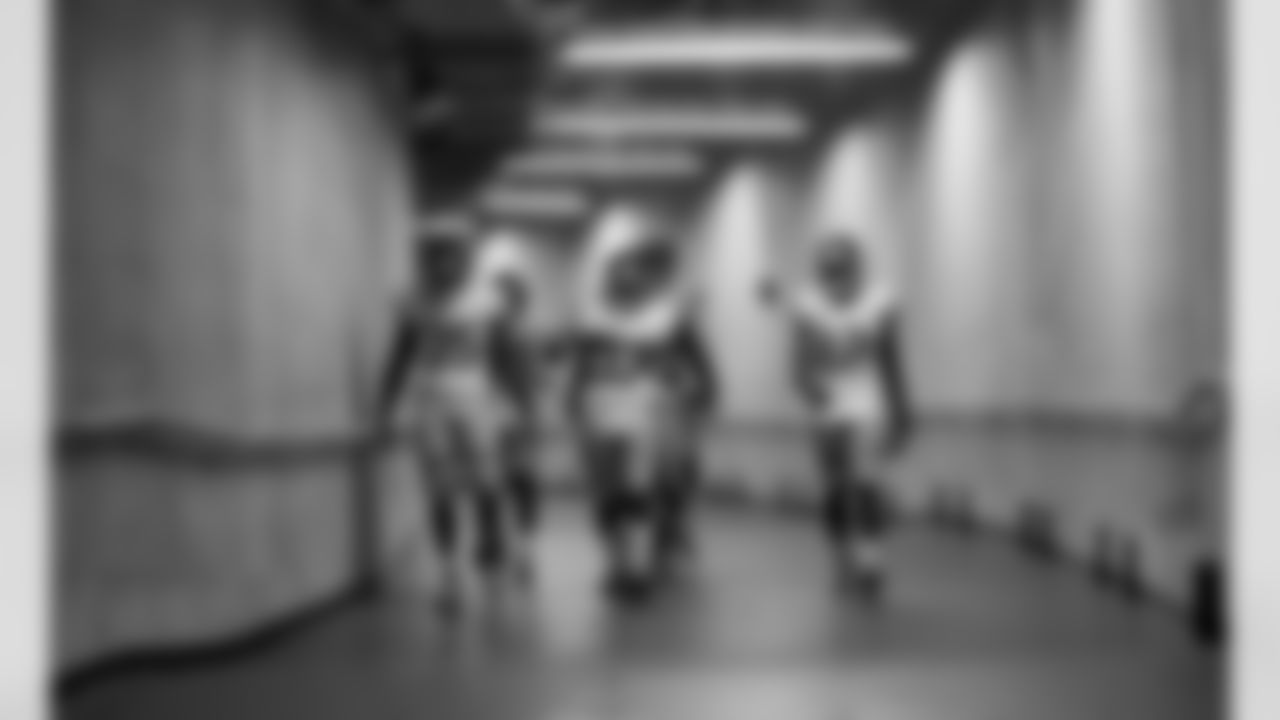 New York Giants running back Andre Brown (35), Charles James (37), and Jerrel Jernigan (12) make their way to the field before an NFL football game against the Detroit Lions in Detroit, Sunday, Dec. 22, 2013. (AP Photo/Paul Sancya)