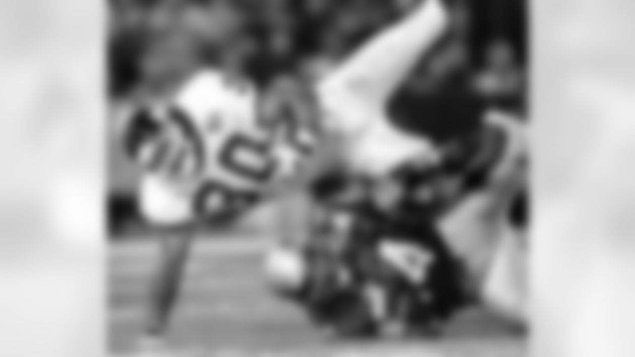 New York Giants Charles Way (30) goes airborne after being tackled by New England Patriots Teddy Bruschi during the first quarter of action Sunday, Sept. 26, 1999, at Foxboro Stadium in Foxboro, Mass. Way gained a first down which led to the Giants' touchdown. (AP Photo/Winslow Townson)