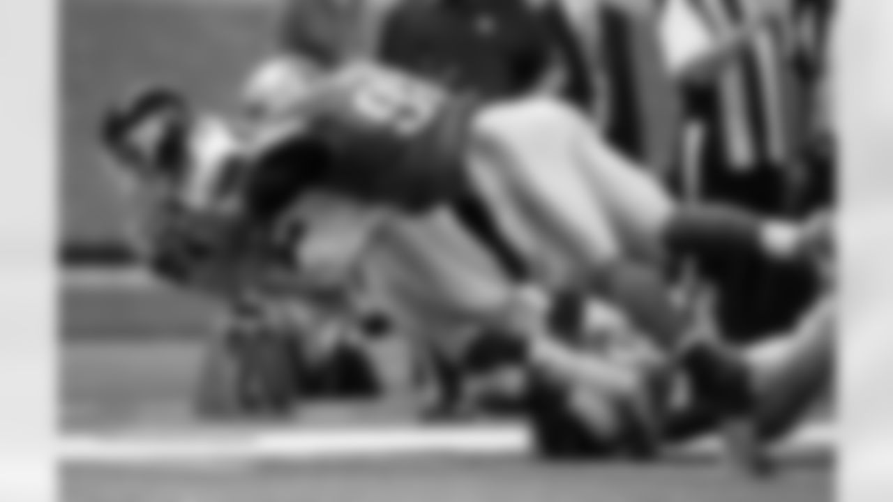 Detroit Lions defensive end Ezekiel Ansah (94) tackles New York Giants wide receiver Rueben Randle (82) during the second quarter of an NFL football game, Sunday, Dec. 22, 2013, in Detroit. (AP Photo/Rick Osentoski)