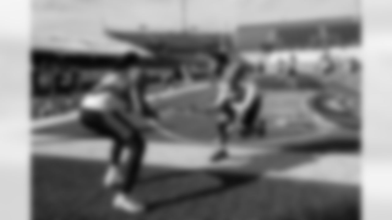 National team offensive lineman Aireontae Ersery of Minnesota (69) and offensive lineman Marcus Mbow of Purdue (63) run through drills during practice for the Senior Bowl NCAA college football game, Wednesday, Jan. 29, 2025, in Mobile, Ala. (AP Photo/Butch Dill)