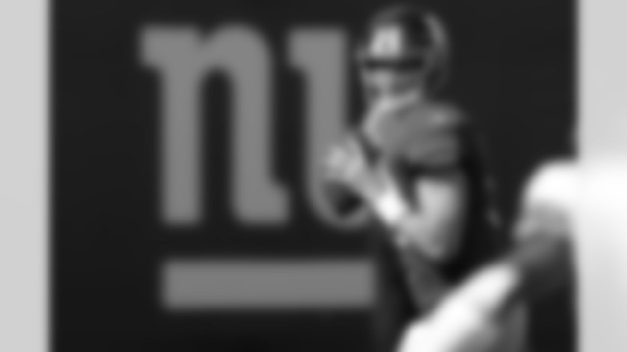 New York Giants quarterback Eli Manning (10) looks to pass during the first quarter of an NFL football game between the Detroit Lions and the New York Giants at New Meadowlands Stadium Sunday, Oct. 17, 2010, in East Rutherford, N.J. (AP Photo/Seth Wenig)