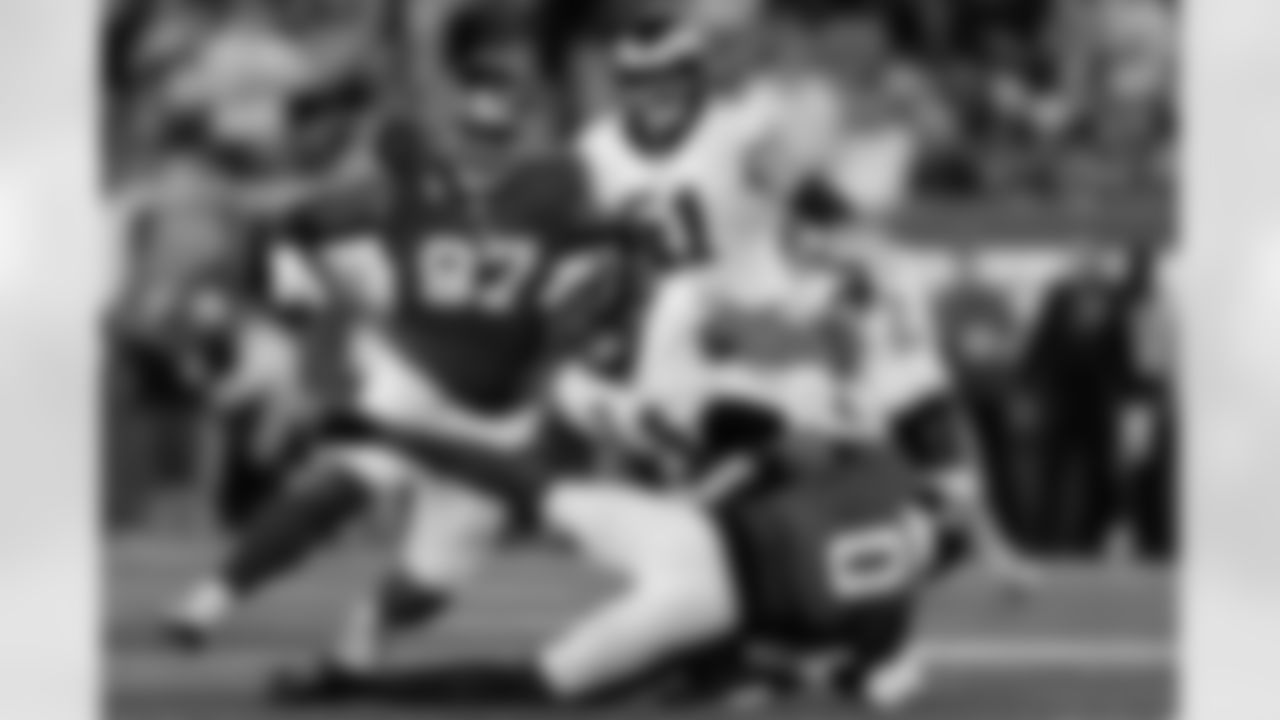 Philadelphia Eagles' Jalen Hurts (1) is sacked by New York Giants' Brian Burns (0) during the second half of an NFL football game Thursday, Oct. 9, 2025, in East Rutherford, N.J. (AP Photo/Adam Hunger)