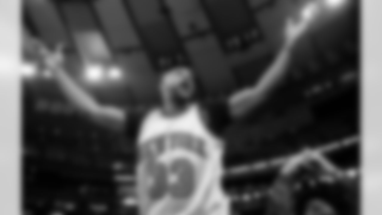 Retired New York Giants wide receiver David Tyree, center, gestures to the crowd as he is introduced during a timeout in the second half of an NBA basketball game between the Brooklyn Nets and the New York Knicks in New York, Sunday, Jan. 26, 2020. Tyree made the famous "helmet catch" in Super Bowl XLII against the New England Patriots. (AP Photo/Kathy Willens)
