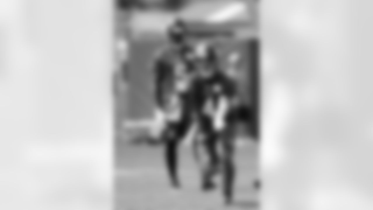 Minnesota Vikings quarterback Mike Kafka (4) tosses the ball to a running back as quarterback Teddy Bridgewater (5) watches during practice at an NFL football training camp on the campus of Minnesota State University Sunday, July 26, 2015, in Mankato, Minn. (AP Photo/Charles Rex Arbogast)