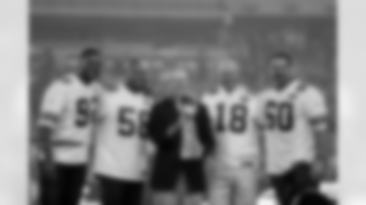 Former New York Giants defensive end Michael Strahan (92), former Giants linebacker Antonio Pierce (58), former Giants coach Tom Coughlin, former Giants punter Jeff Feagles (18), and former Giants center Shaun O'Hara (60) pose for a photograph with the Super Bowl Trophy after a tribute to the Giants Super Bowl XLII win at halftime during the 2017 NFL week 2 regular season football game against the against the Detroit Lions, Monday, Sept. 18, 2017 in East Rutherford, N.J. The Lions won the game 24-10. (Paul Spinelli via AP)