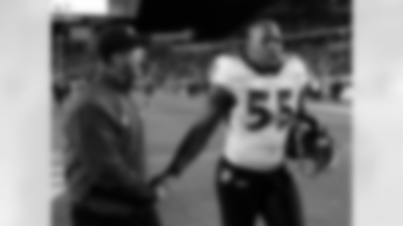 Baltimore Ravens head coach John Harbaugh celebrates with Terrell Suggs after Baltimore defeated the Cincinnati Bengal 24-16 in an NFL football game Sunday, Jan. 1, 2012, in Cincinnati. (AP Photo/Darron Cummings)